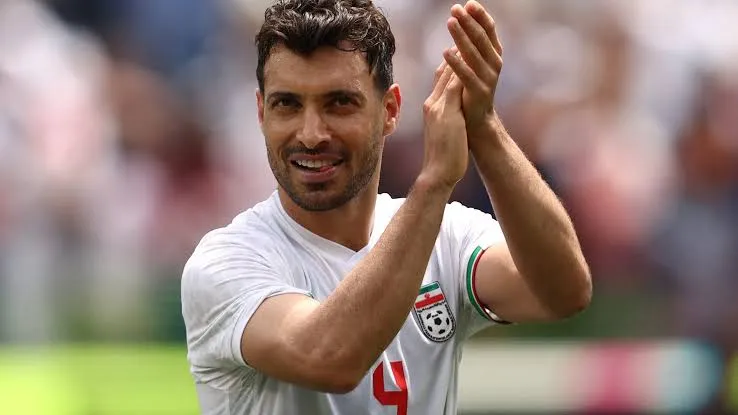 Iran player celebrating after Iran World Cup match and draw against Belgium