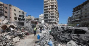 Damaged buildings and destroyed vehicles in southern Lebanon following conflict as Israel Lebanon Ceasefire negotiations continue.