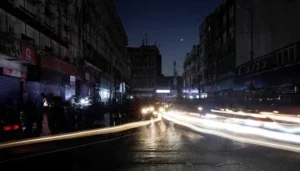 Dark street scene during Karachi Load Shedding with vehicles and businesses affected by electricity outage