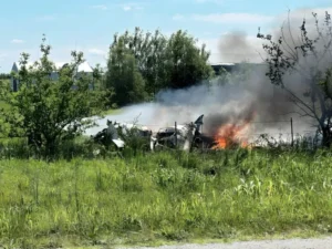 Missouri plane crash wreckage burning in a field near Butler Memorial Airport with smoke rising after the tragic accident