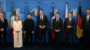 NATO leaders and Ukrainian President Volodymyr Zelensky pose during a summit meeting as NATO Spending commitments increase.