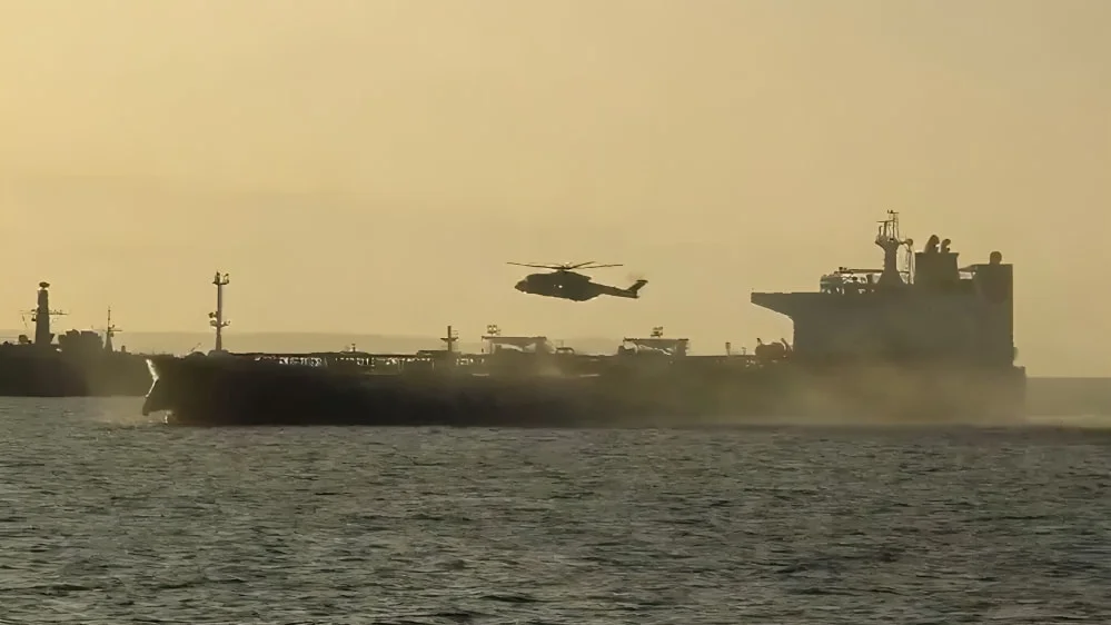 UK Royal Marine Commandos helicopter approaching Russian shadow fleet tanker during interdiction operation in the English Channel
