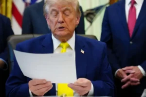 Donald Trump reviewing official documents amid legal scrutiny over Trump Immigration Policies affecting immigrants from 39 countries.
