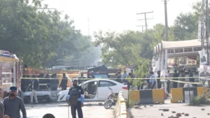 Forensic officials inspect a damaged passenger bus following an explosion, related to Twin Bannu Blasts.