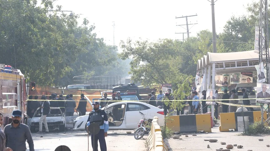 Forensic officials inspect a damaged passenger bus following an explosion, related to Twin Bannu Blasts.