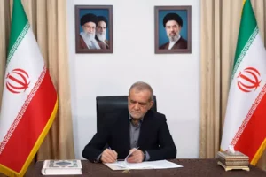 Iranian President Masoud Pezeshkian signing documents related to the US Iran Deal during ongoing peace negotiations.