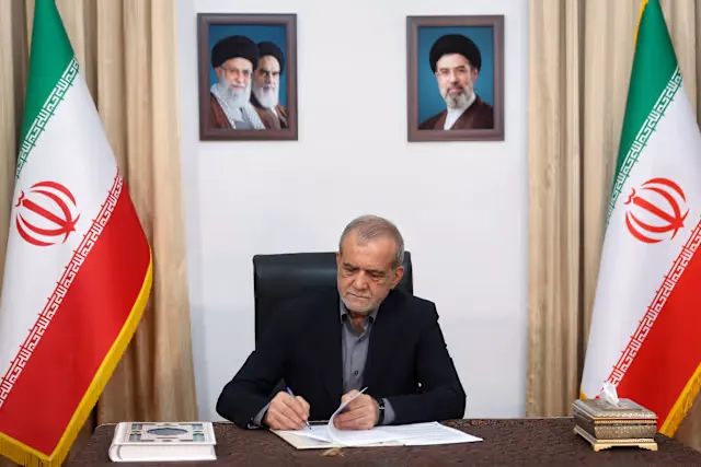 Iranian President Masoud Pezeshkian signing documents related to the US Iran Deal during ongoing peace negotiations.