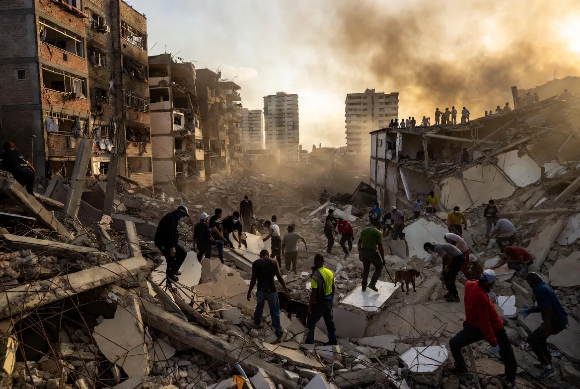 Dramatic view of collapsed buildings and rescue teams searching through rubble after the powerful Venezuela earthquakes in La Guaira, showing the urgent humanitarian response following the deadly twin quakes.