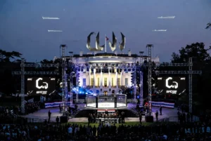 President Donald Trump attending UFC Freedom 250 event on the White House South Lawn during America's 250th anniversary celebrations with illuminated "The Claw" fighting arena