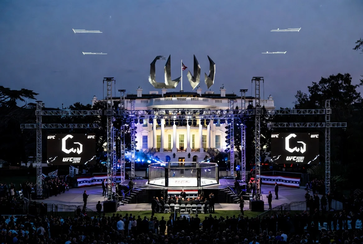 President Donald Trump attending UFC Freedom 250 event on the White House South Lawn during America's 250th anniversary celebrations with illuminated "The Claw" fighting arena