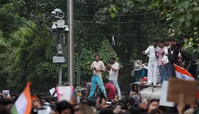 Crowds gather near an AI powered police surveillance camera during the AI surveillance protest in New Delhi.
