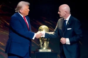 Donald Trump shakes hands with FIFA President Gianni Infantino after the Balogun Red Card suspension was overturned.