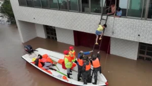 Rescue workers evacuate residents by boat during China Storms after severe flooding submerged residential areas.