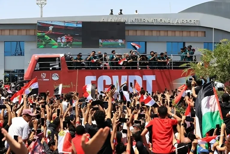 Egypt fans welcome the national football team outside Alamein International Airport after the historic Egypt World Cup campaign.