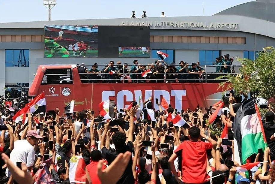 Egypt fans welcome the national football team outside Alamein International Airport after the historic Egypt World Cup campaign.