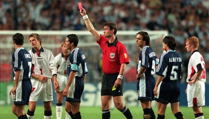 England Argentina Rivalry highlighted as a referee shows a red card during a historic FIFA World Cup match between England and Argentina.