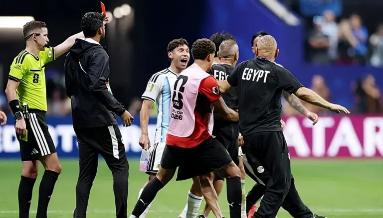 Referee issues a red card during the Argentina vs Egypt World Cup match as FIFA Bias allegations emerge after the controversial Round of 16 clash.