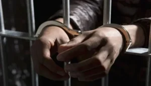 Foreign Women's Assault case representation showing a handcuffed suspect behind prison bars as Lahore court extends the physical remand of four accused.