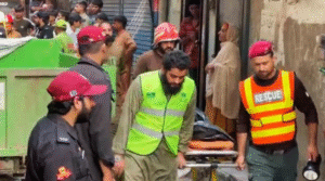 Rescue workers carrying a victim on a stretcher after a house roof collapsed in Lahore's Baghbanpura area, Pakistan.