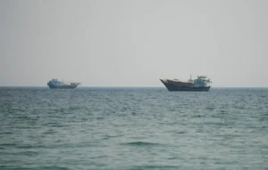 Iran Maritime Blockade showing commercial vessels sailing near the Strait of Hormuz as the United States begins enforcing maritime restrictions on Iranian waters.