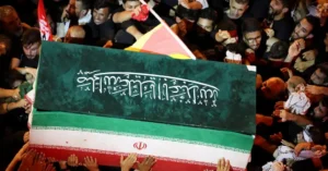 Crowds carry the coffin during the Iran Khamenei funeral procession in Mashhad as regional tensions continue to escalate.