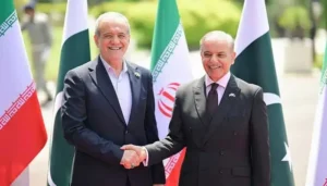 Prime Minister Shehbaz Sharif shakes hands with Iranian President Masoud Pezeshkian during discussions on Iran Pakistan Peace and regional stability.