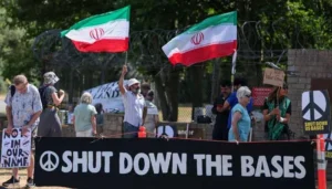 Protesters hold Iranian flags during an Iran war demonstration outside RAF Fairford airbase in Britain.