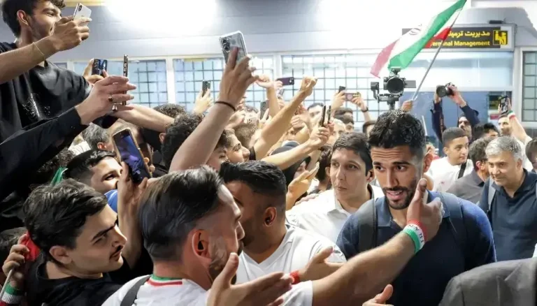 Iran World Cup squad receives a warm welcome from fans at Tehran airport after the FIFA World Cup.