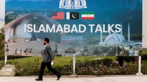 Billboard highlighting Islamabad MoU and US Iran peace talks in Islamabad with Pakistan, US, and Iran flags displayed.