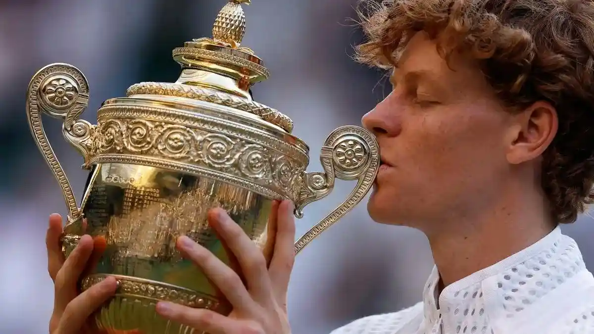 Jannik Sinner kisses the Wimbledon trophy after defeating Alexander Zverev to retain the Wimbledon title.
