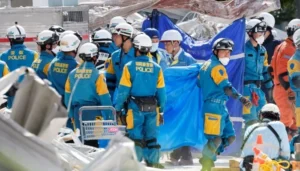 Japanese rescue workers search earthquake rubble as Japan earthquake toll reaches 28