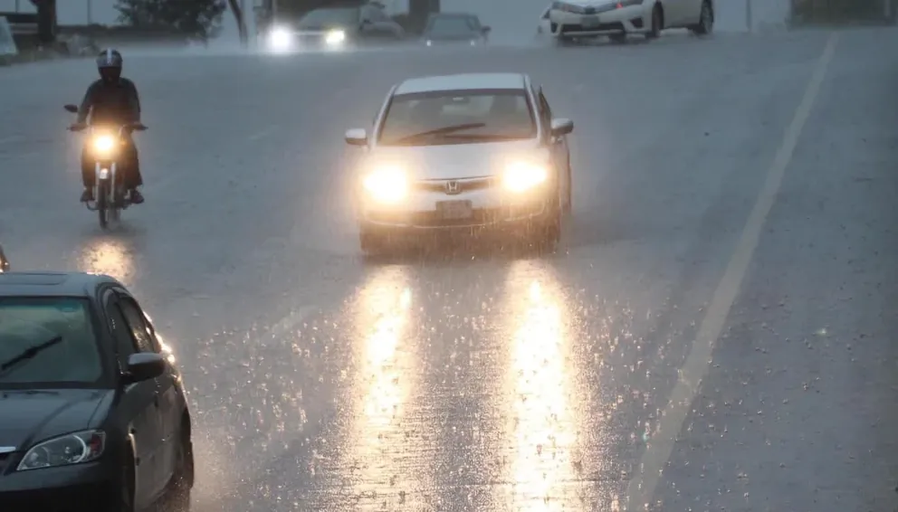 Vehicles driving through heavy rainfall in Karachi during monsoon weather as Karachi Rain continues across the city.