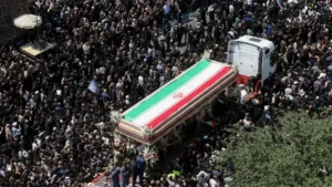 Thousands of mourners attend the Khamenei Funeral procession as the coffin draped in the Iranian flag moves through Tehran.