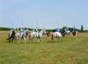 Riders on horseback compete in the London Nezabazi tent pegging event, showcasing Pakistan's traditional equestrian sport in the United Kingdom.