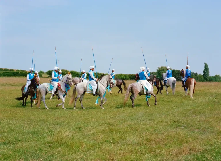 Riders on horseback compete in the London Nezabazi tent pegging event, showcasing Pakistan's traditional equestrian sport in the United Kingdom.
