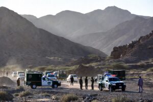 Security forces at the site of Mastung Judge Attack in Balochistan with police vehicles and cordoned area in arid mountainous landscape