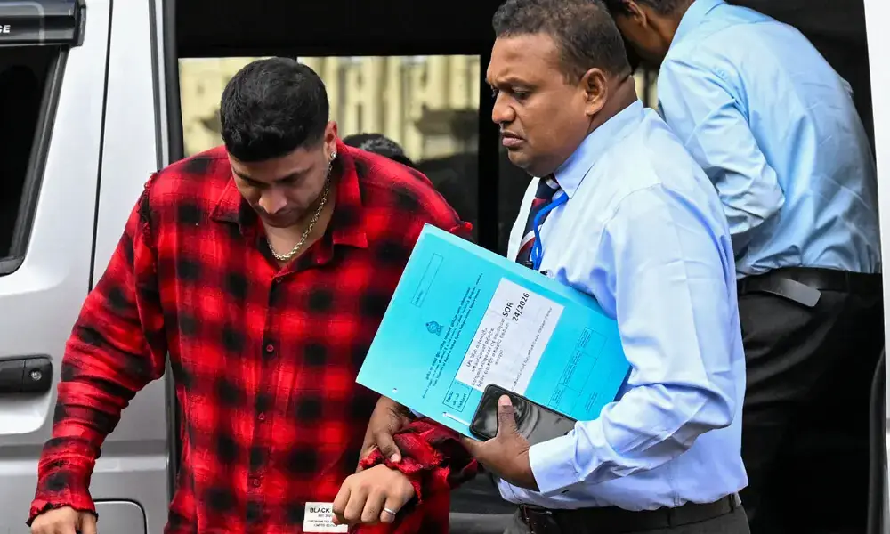 Match Fixing suspect Manjot Kalra is escorted by Sri Lankan authorities after his arrest in Colombo over alleged player bribery.