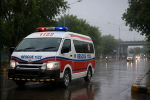 Monsoon Safety Rescue 1122 emergency ambulance on a rain soaked road during the monsoon season.