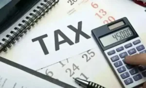 Calculator placed on tax documents representing Multan Tax Recovery after the Excise Department exceeded its annual tax collection target by achieving 104% recovery.