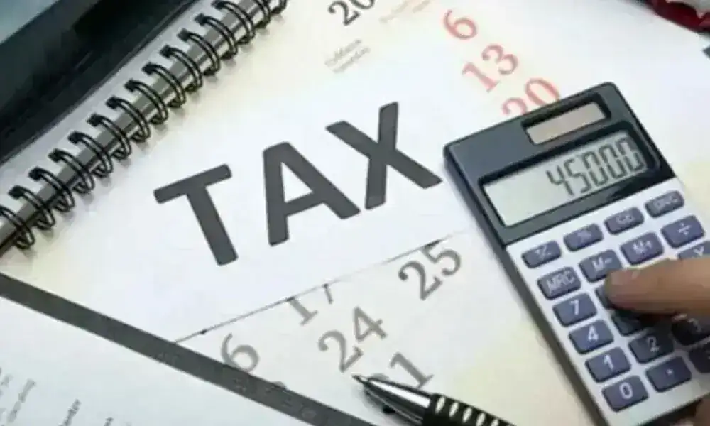 Calculator placed on tax documents representing Multan Tax Recovery after the Excise Department exceeded its annual tax collection target by achieving 104% recovery.