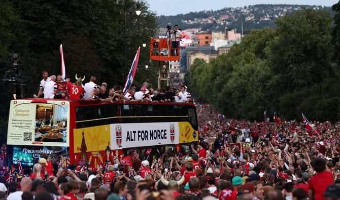Norway World Cup players celebrate with thousands of supporters during the homecoming bus parade in Oslo after their memorable FIFA World Cup campaign.