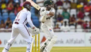 Pakistan batsman playing a shot during the Pakistan vs West Indies Test match while the West Indies wicketkeeper watches behind the stumps.