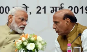 Rajnath Singh speaks with Indian Prime Minister Narendra Modi during an official government meeting amid political controversy.