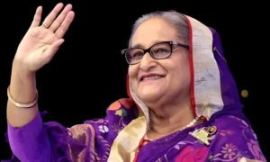 Sheikh Hasina waving during a public appearance as reports emerge about her planned return to Bangladesh and court surrender.