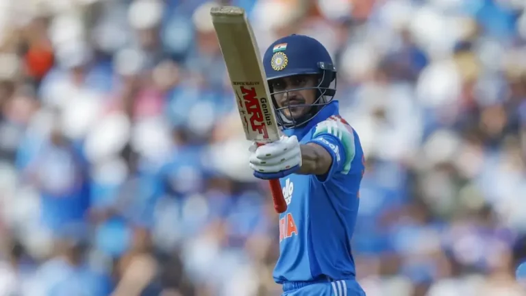 Shubman Gill raises his bat while batting for India during an international cricket match.