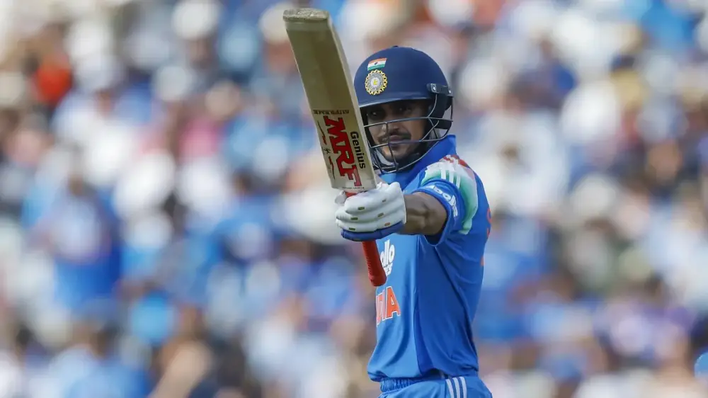 Shubman Gill raises his bat while batting for India during an international cricket match.