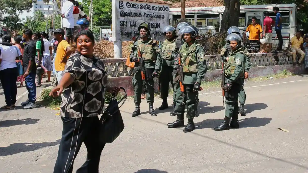 Security personnel stand guard outside a detention facility following the Sri Lanka prison clash that left multiple people dead and injured.