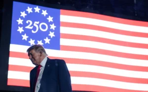 Trump Identity speech as Donald Trump stands before the US 250th anniversary flag during Independence Day celebrations.