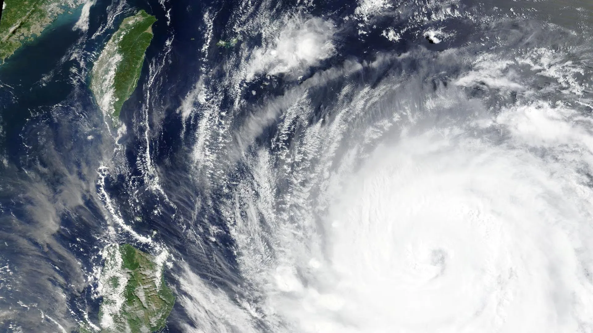 Satellite image of Typhoon Bavi approaching Japan's southwestern islands and Taiwan with powerful winds and heavy rain.