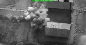 US Iran Conflict showing smoke rising after an airstrike targeting infrastructure during the latest exchange of attacks.